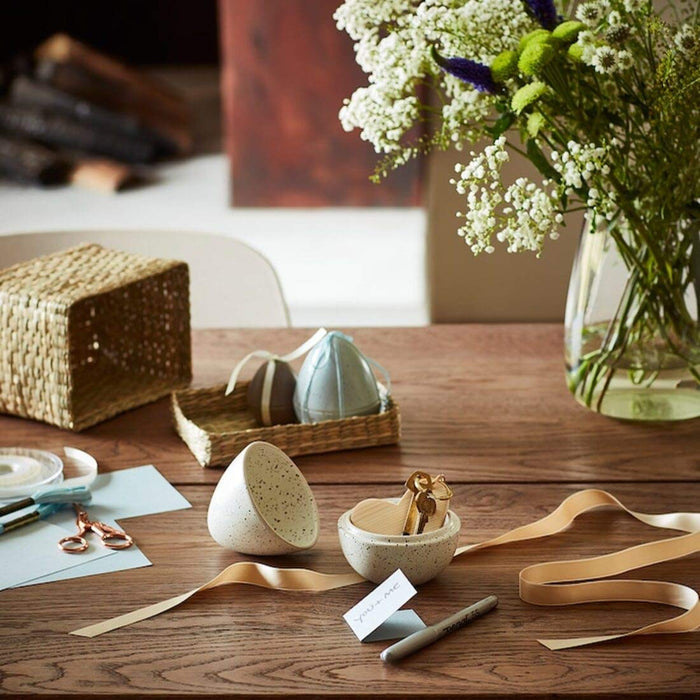 An egg-shaped decoration on a table, a perfect addition to any minimalist or Scandinavian-style home decor 40466308