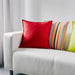 Multiple IKEA cushion covers in different colors and designs on a sofa -50281149