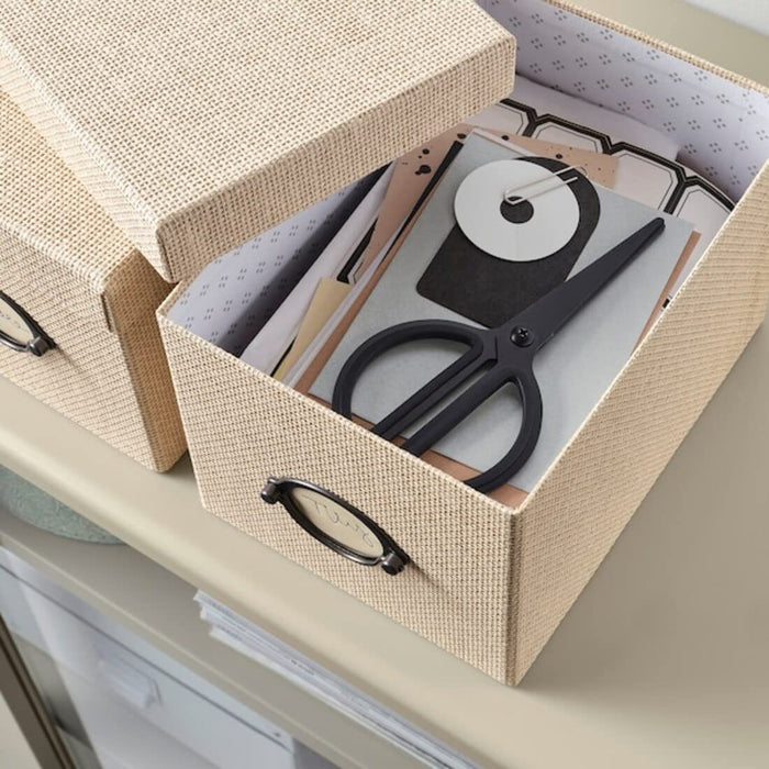 A sturdy cardboard box from IKEA, designed for storage purposes, with a removable lid to keep contents safe and secure.