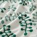 A close-up image of a folded Green/White hand towel with a textured pattern 20494388