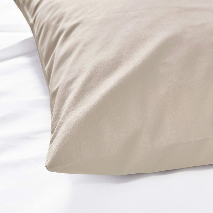 The edge of a beige pillowcase from IKEA, highlighting its bright and cheerful color 