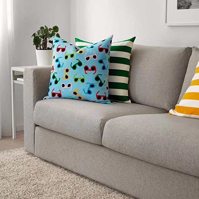 Multiple IKEA cushion covers in different colors and designs on a sofa-30426209