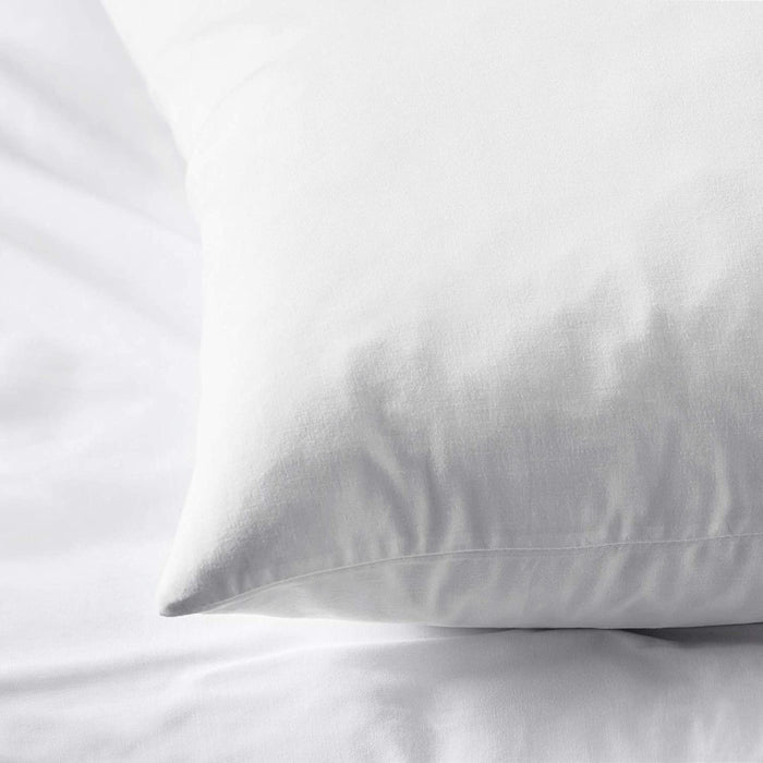 The edge of a white pillowcase from IKEA, highlighting its bright and cheerful color