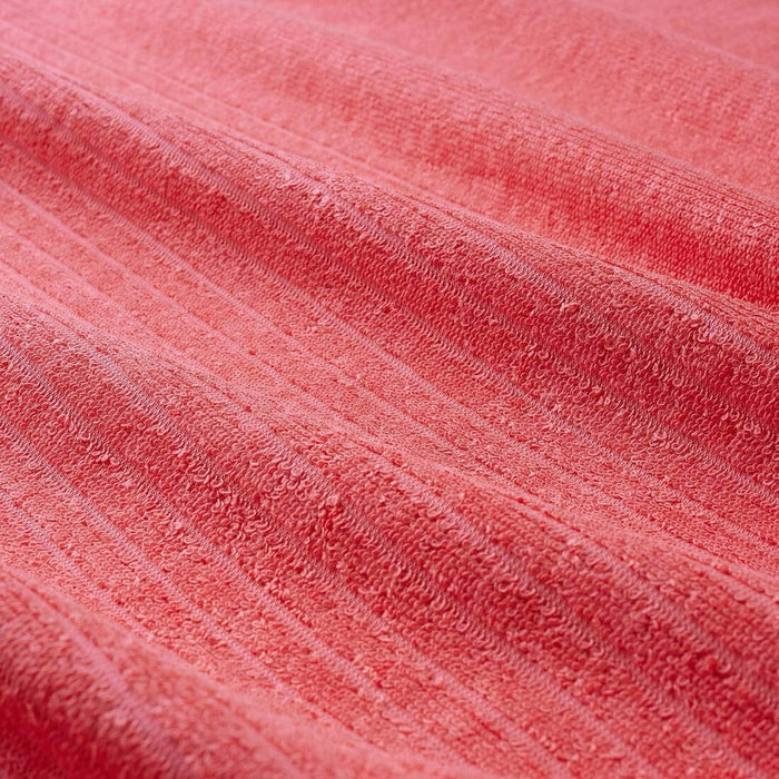 A close-up image of a folded red hand towel 00439430