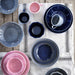 Stoneware bowl in a colorful table setting 904431641