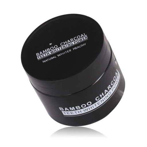 A close-up of the bamboo charcoal teeth whitening powder, showing its fine texture.