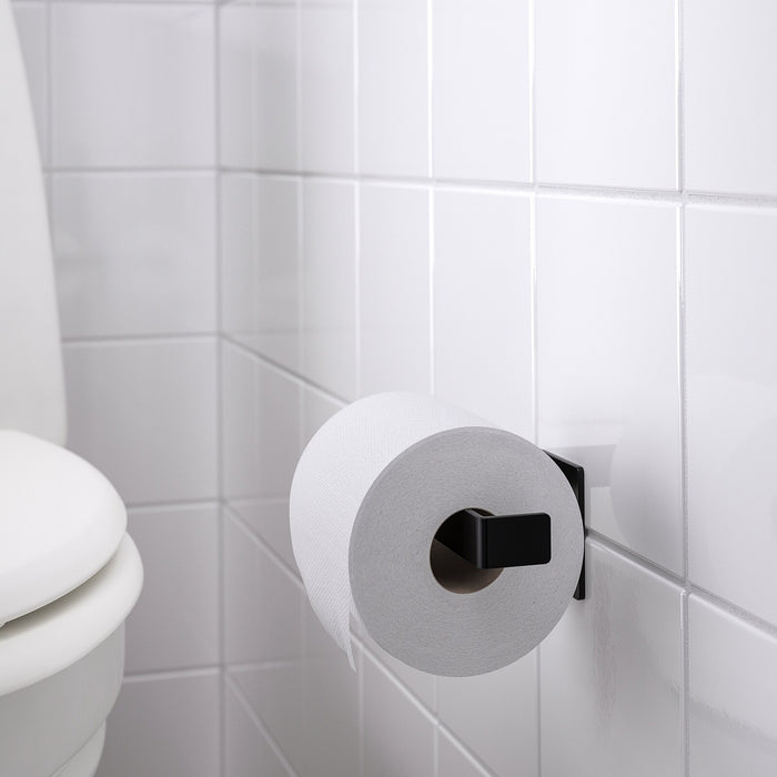 An image of the toilet roll holder mounted on the wall of a small bathroom, demonstrating its space-saving benefits.