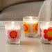 A round glass tealight candleholder with a white unscented candle.