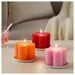 A set of IKEA Unscented Block Candles in various colors and sizes, adding warmth and ambiance to a table setting.