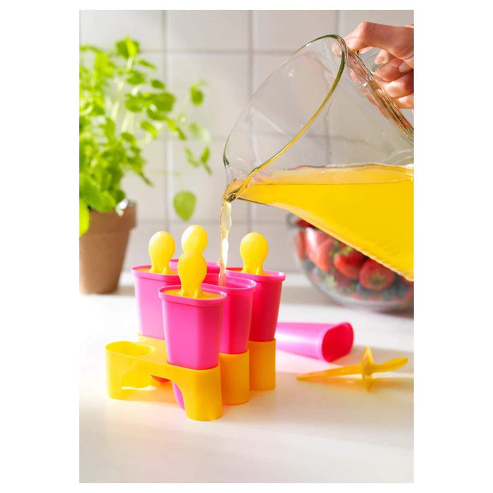 A stack of four IKEA silicone popsicle molds, in pastel pink and blue, with a blue and white stand to keep them upright while freezing.-60208479