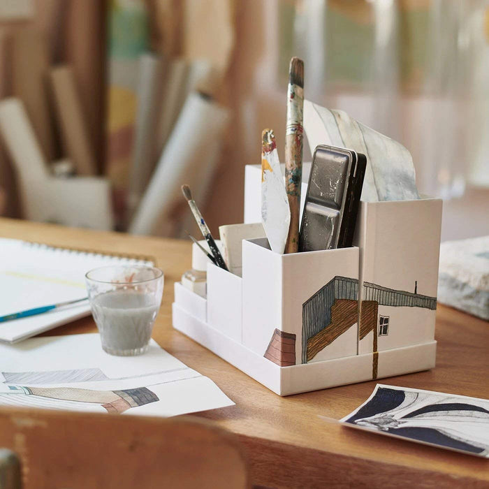 IKEA's desk organizer on it, showing how it maximizes desk space and keeps stationery and other essentials within easy reach.