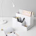A desk organizer with multiple trays and compartments for storing stationery and office supplies.