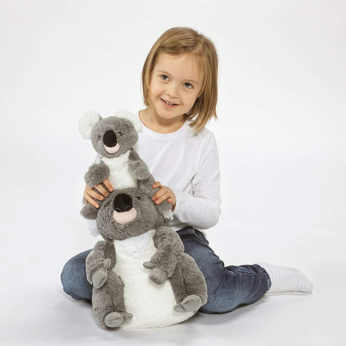 The IKEA Soft Toy Koala sitting on a shelf, surrounded by other stuffed animals and toys.