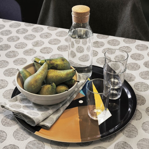 A simple and elegant round serving tray from IKEA, made of clear plastic with a glossy finish and minimalist design 60472445