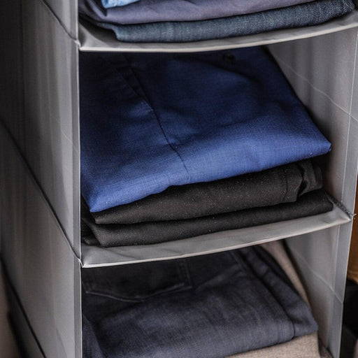IKEA SKUBB dark grey fabric shelf organiser with folded clothes in three visible compartments mesh design