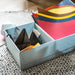 A blue box with multiple compartments designed for storing crafting materials, featuring a colorful design and several compartments to accommodate various papers 60493914