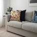 Multiple IKEA cushion covers in different colors and designs on a sofa-70522727