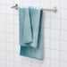 A bath towel hanging on a hook on the back of a bathroom door.50494315 