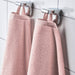 A close-up image of a simple and classic pink hand towel hanging on a bathroom70488016