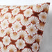 A closeup image of ikea cushion cover Orange/Beige color with a floral pattern-20492073