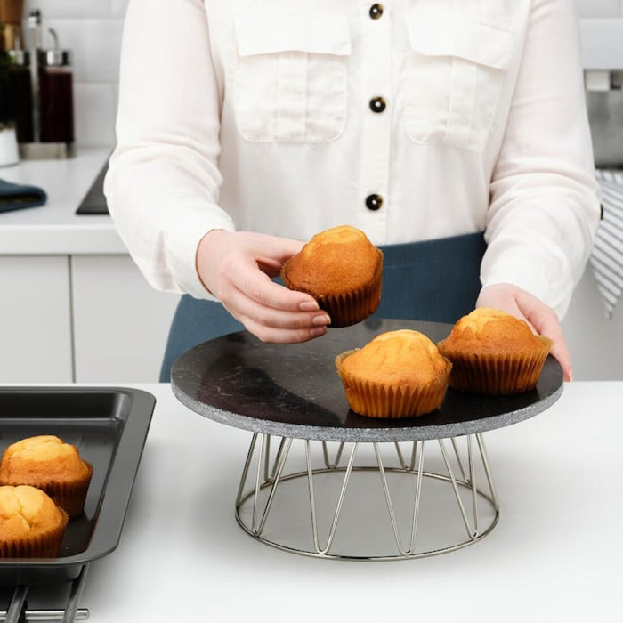 "A clear glass cake stand with a sleek, contemporary design from IKEA.