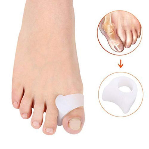 Small silicone toe separator being placed between the big toe and second toe on a white background