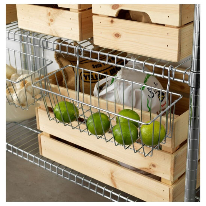 IKEA clip-on basket attached to a shelf, holding various kitchen items