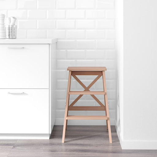 An Ikea Stepladder being folded and stored in a small space, highlighting the product's compact and versatile design70190412