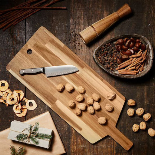 A chef's essential tool, an IKEA bamboo chopping board in a large size for heavy-duty use.