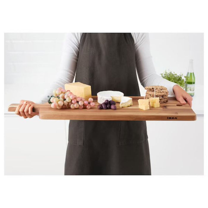 An IKEA bamboo chopping board featuring a smooth surface and a handle for easy carrying.