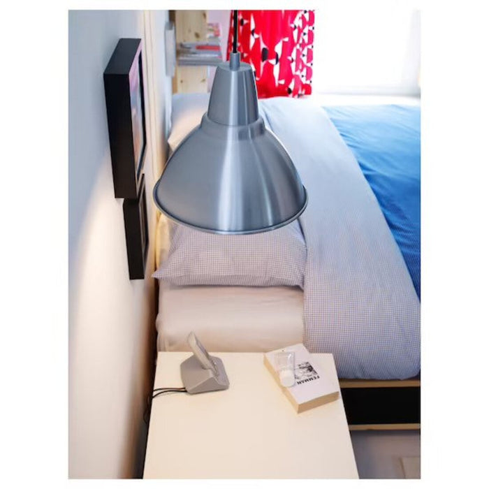 A minimalist pendant lamp with a simple white shade hanging in a serene bedroom. 40423385