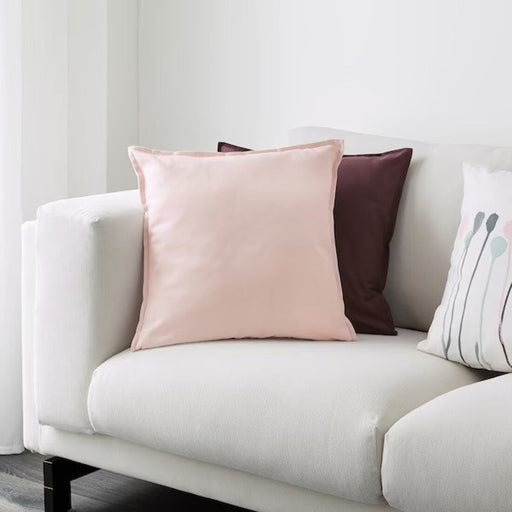 Multiple IKEA cushion covers in different colors and designs on a sofa-00343630