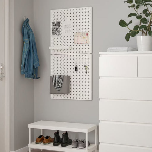 An organized workspace with multiple IKEA pegboards connected by connectors, showcasing the brand's adaptable and customizable storage solutions. 90477644 