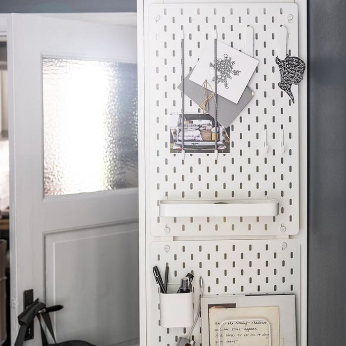 An IKEA pegboard connector with a slim and unobtrusive design, allowing for maximum use of the pegboard surface while connecting multiple boards. 90477644 
