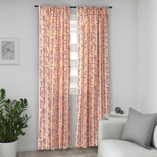 IKEA curtain with floral pattern, hanging from a rod.