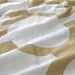 A close-up shot of IKEA's duvet cover in a soft white/light beige-green color with a matching pillowcase