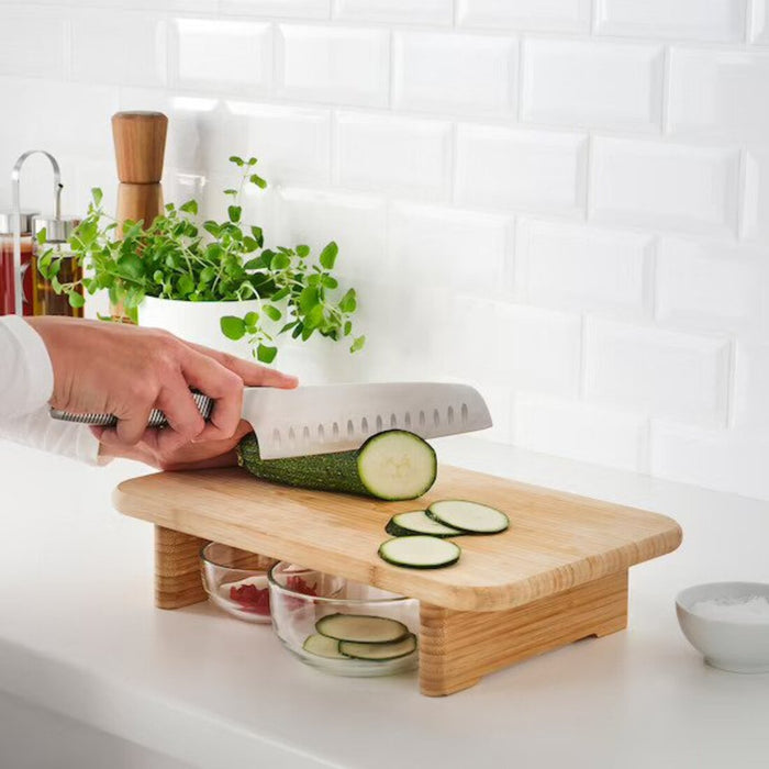 A sturdy IKEA plastic cutting board with a built-in colander, allowing you to rinse and drain fruits and vegetables directly on the board.