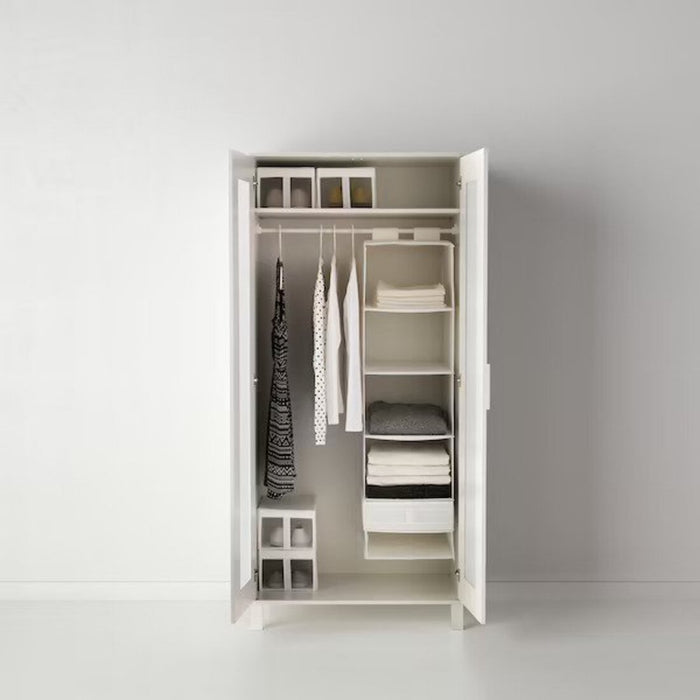 A close-up of an IKEA storage unit with 6 compartments and adjustable shelves.