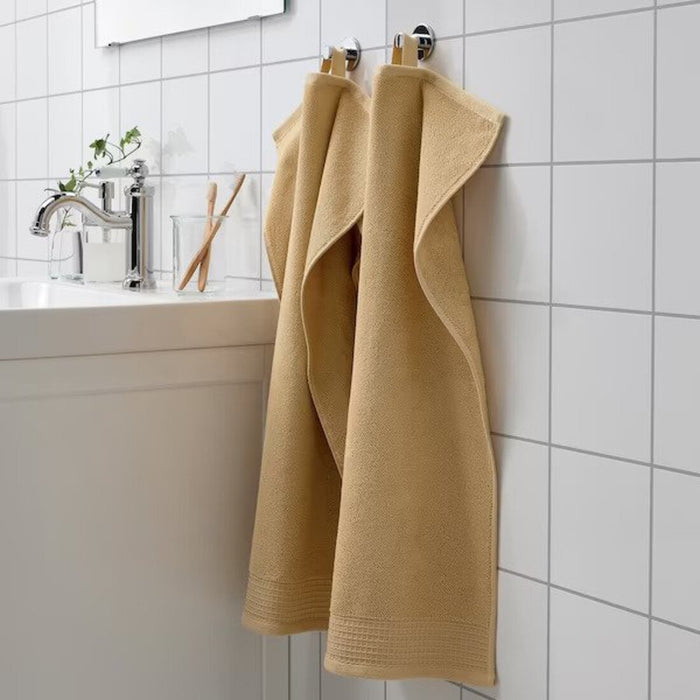 A classicLight yellow hand towel with a simple and elegant border design, perfect for any bathroom 70508340