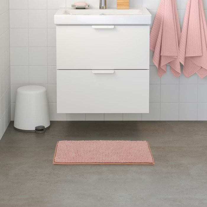 IKEA bath mat placed on a bathroom floor, featuring a soft and absorbent texture and a non-slip bottom for secure footing 90517027
