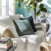 Multiple IKEA cushion covers in different colors and designs on a sofa-10432678
