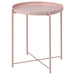 "The IKEA tray table in pale pink shown in a home setting. It is being used as a side table and has a vase of flowers and a book on top, highlighting its versatility.