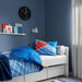 A cozy-looking bed with a colorful duvet cover and matching pillowcase from IKEA  80491377