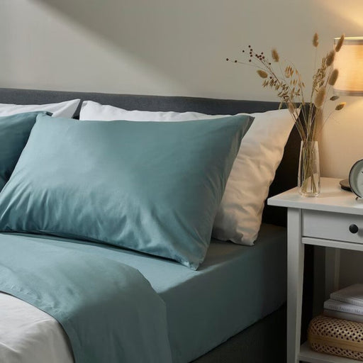 A blue cotton pillowcase from IKEA lying on a bed adding a touch of elegance to the bedding 50501698  