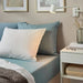 A blue cotton pillowcase from IKEA lying on a bed adding a touch of elegance to the bedding 50501698 