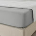 A closeup image of IKEA fitted sheet on a bed with neatly tucked corners and a smooth surface  20482451 