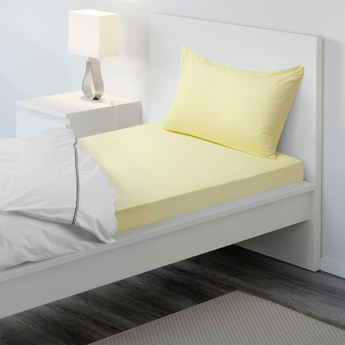 Yellow cotton flat sheet and pillowcase from IKEA on a bed  20454797
