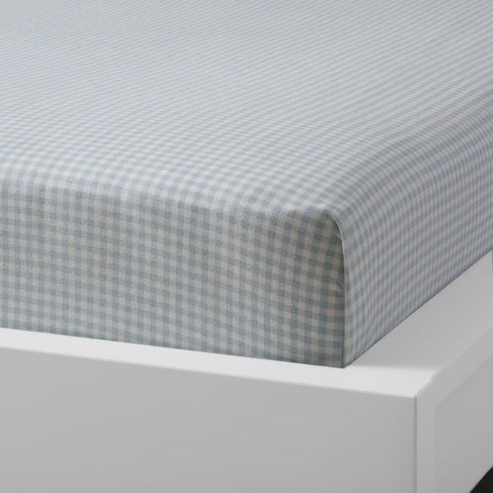 Blue cotton flat sheet and pillowcase from IKEA draped on a bed  00454798