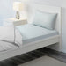 Blue cotton flat sheet and pillowcase from IKEA on a bed  00454798