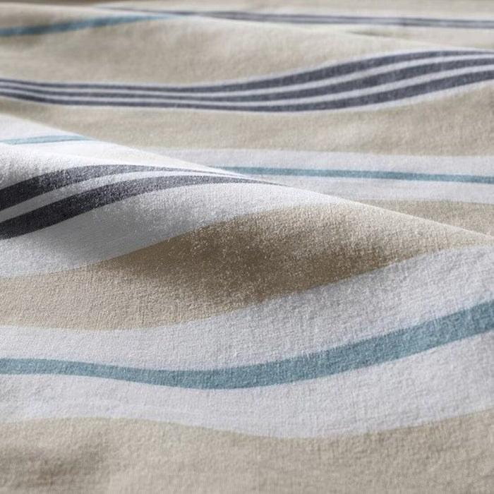 A closeup image of beige/blue duvet cover with a striped pattern   20443515 